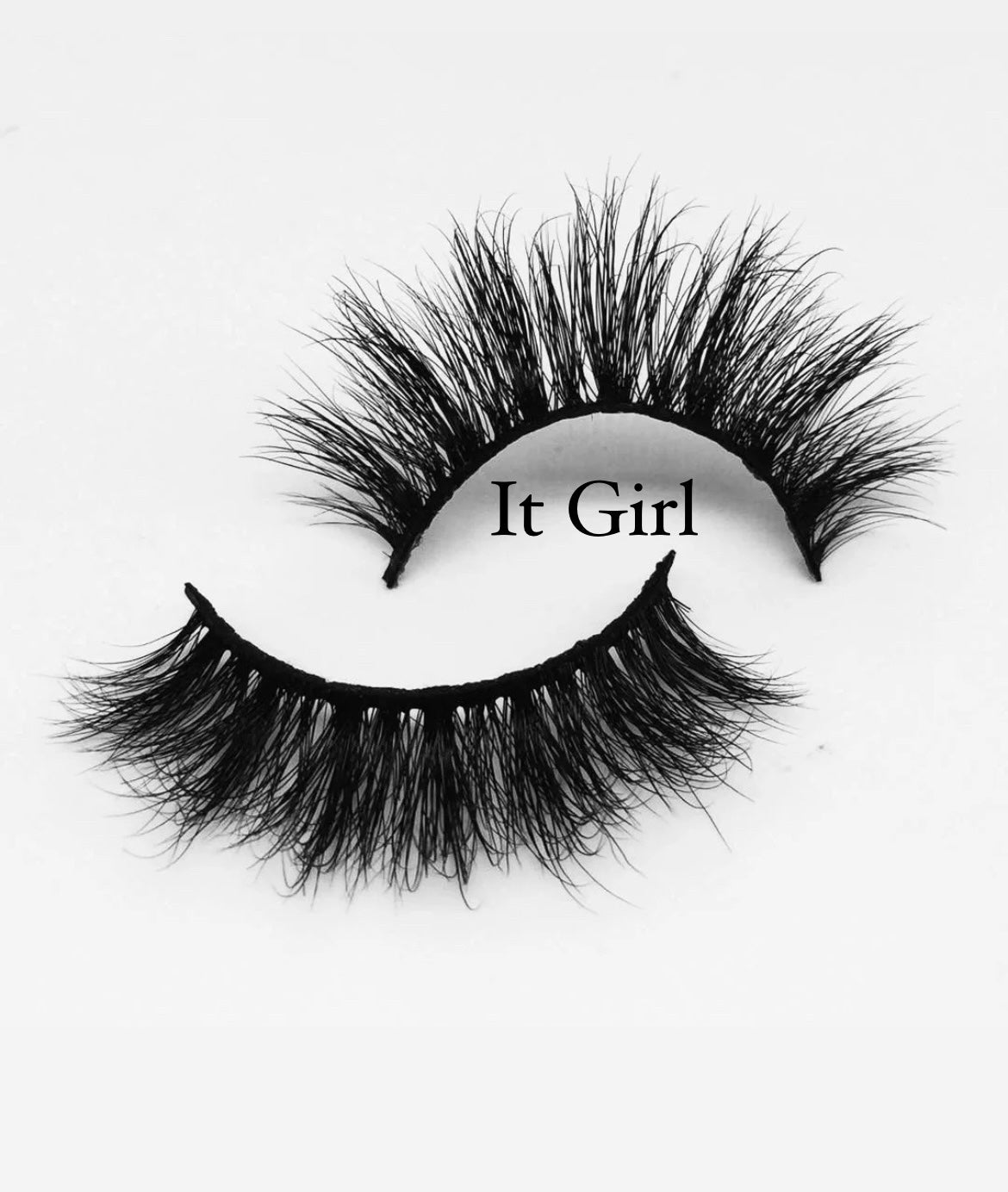 A pair of dramatic, voluminous false eyelashes labeled "MesmerEyes Mink Lashes" by Nayy Seduction Brand are displayed against a white background. The lashes are dense and tapered, giving a bold and glamorous appearance.